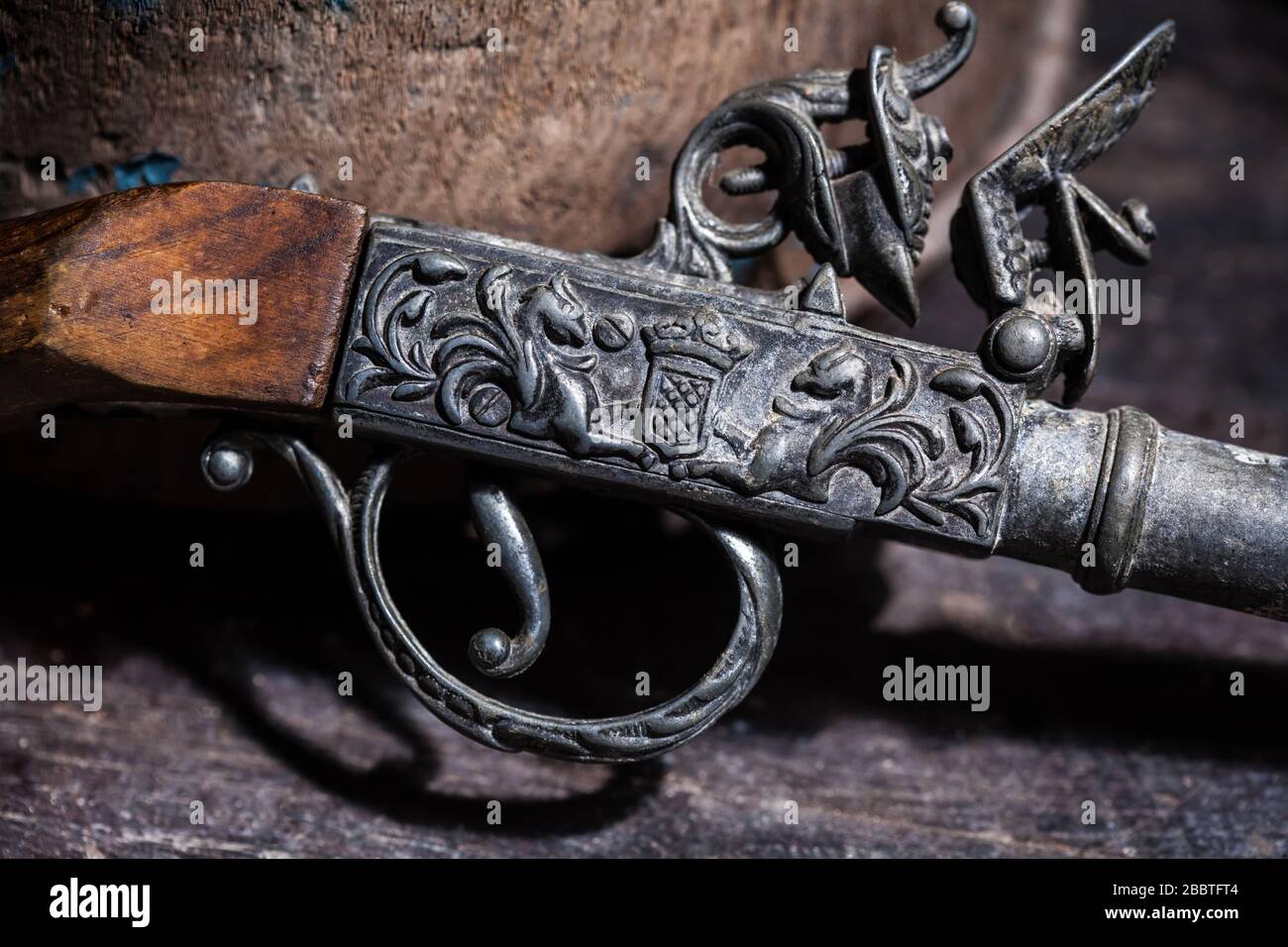 Model of the old vintage gun on wooden background Stock Photo - Alamy