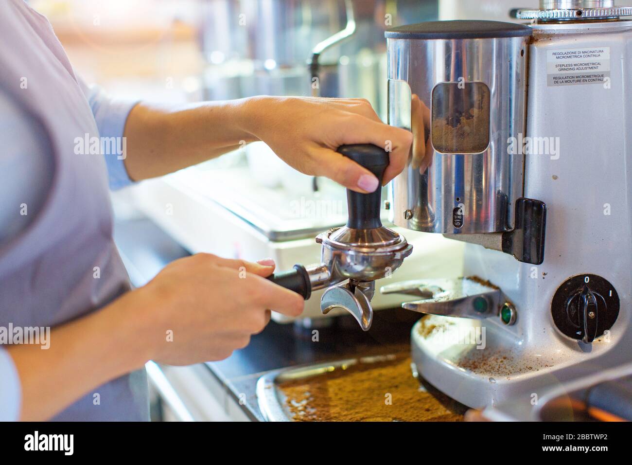 Female barista making coffee Stock Photo