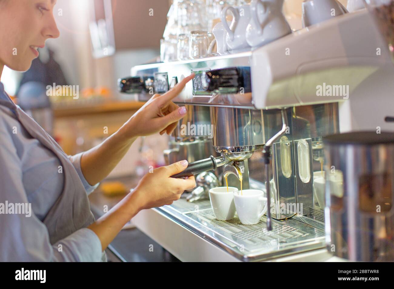 Female barista making coffee Stock Photo