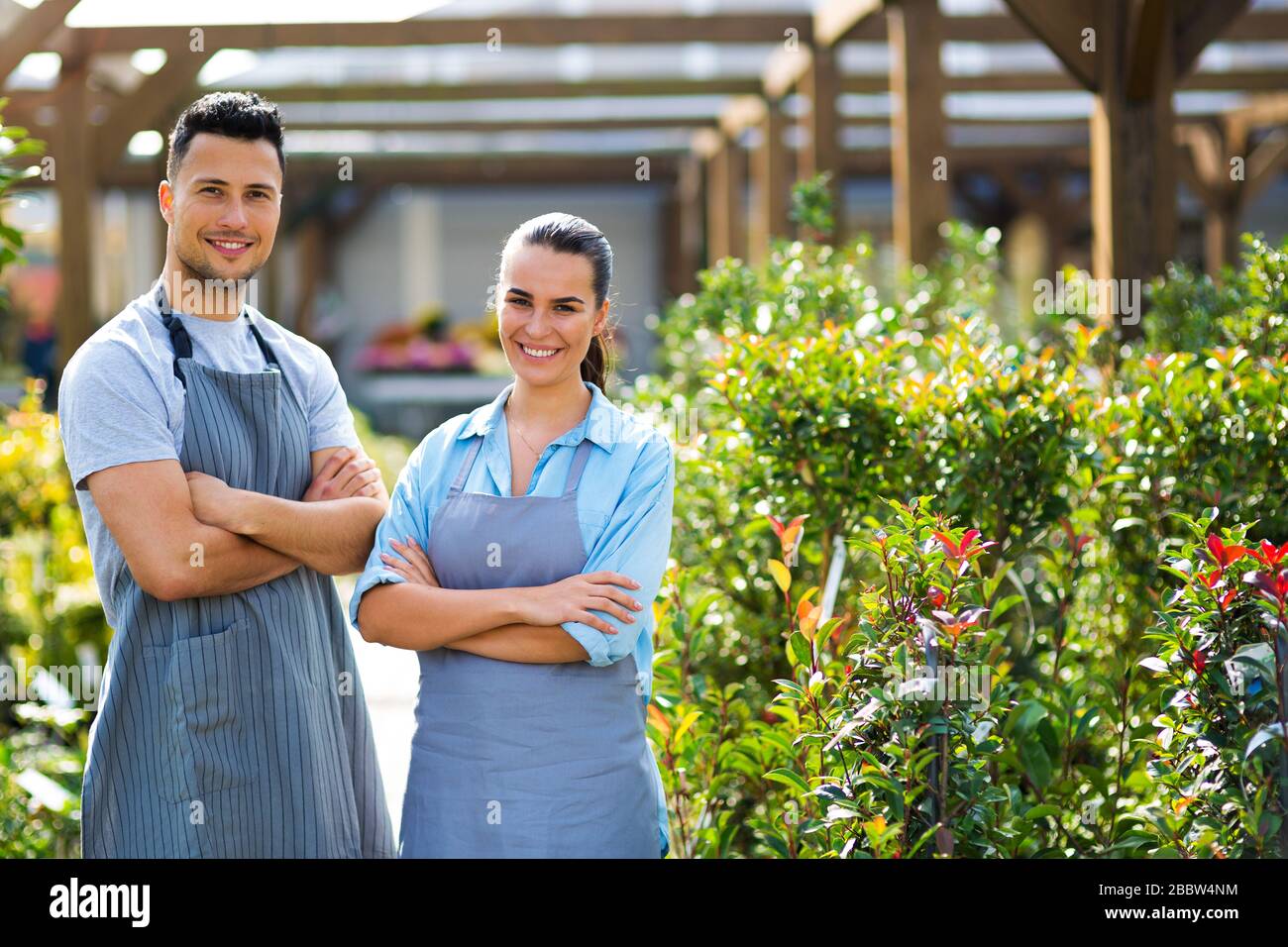 Smiling employees in garden center Stock Photo - Alamy
