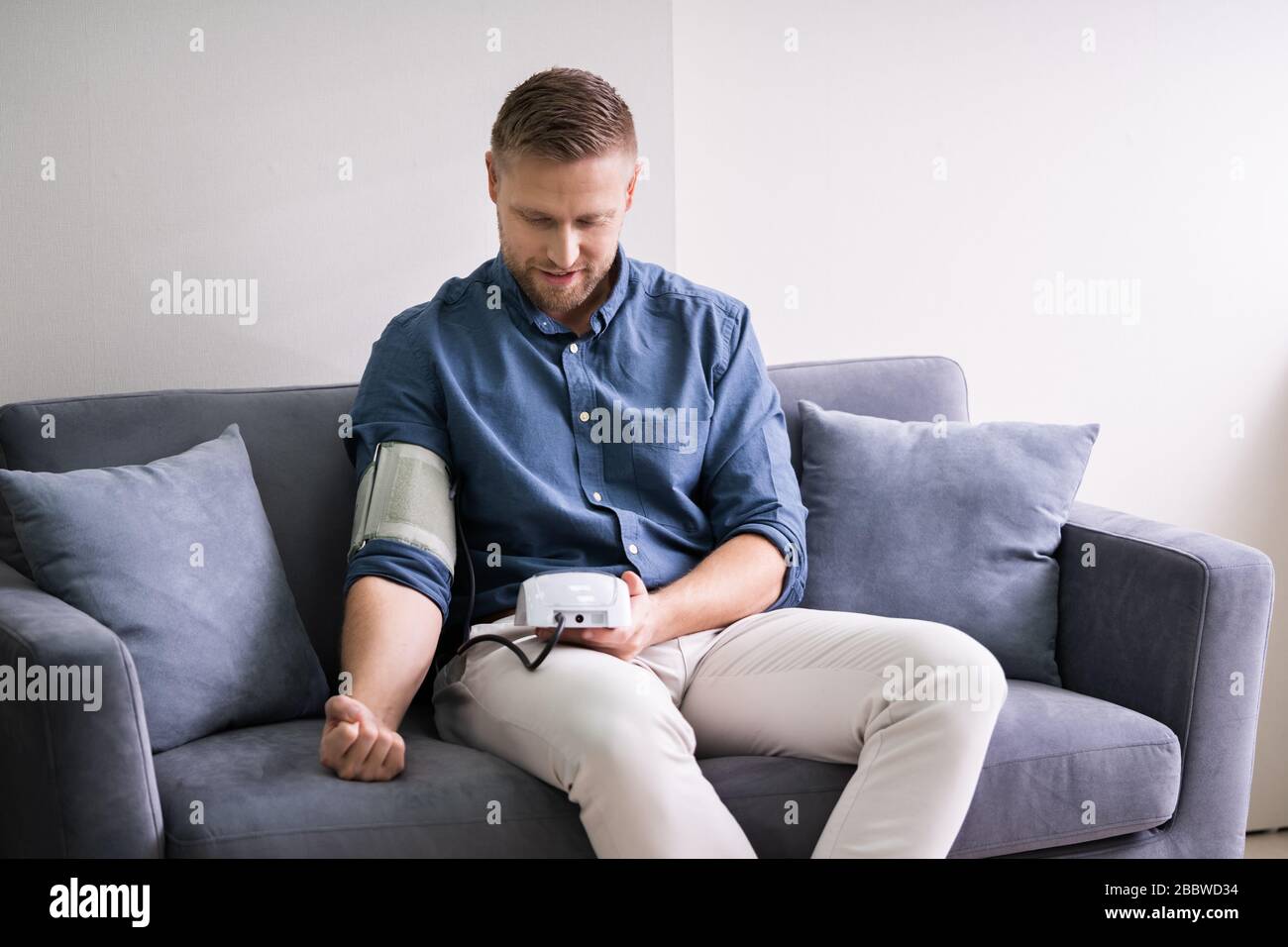 Man Checking Blood Pressure At Home. Chronic Disease Stock Photo