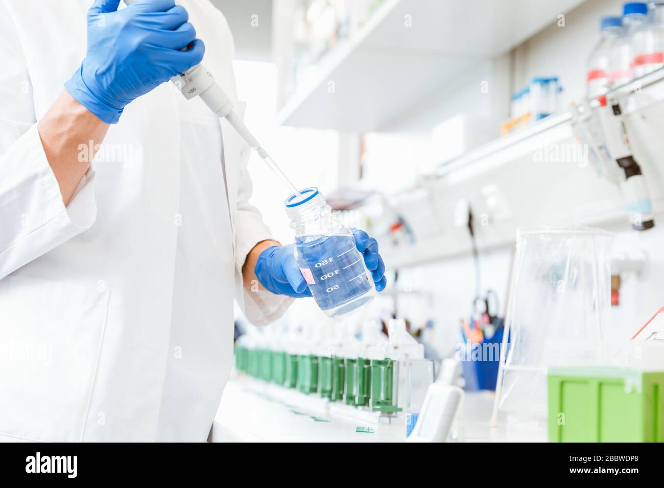 Doctor using dropper for experiment Stock Photo Alamy