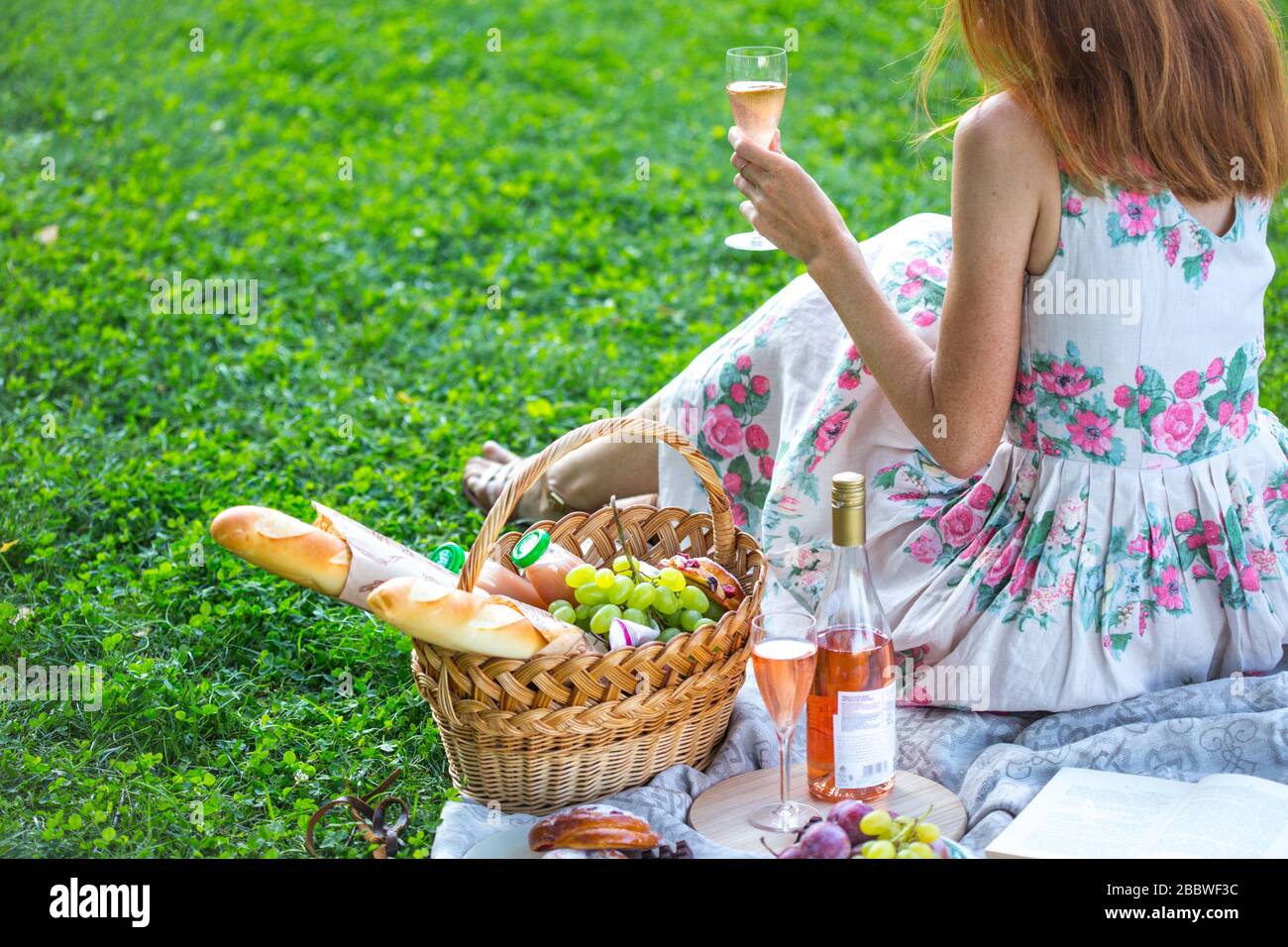 Summer - picnic in the meadow. girl with a glass of wine and near a ...