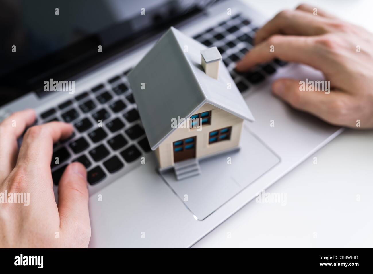 Real Estate House Model Near Laptop On Desk Stock Photo Alamy
