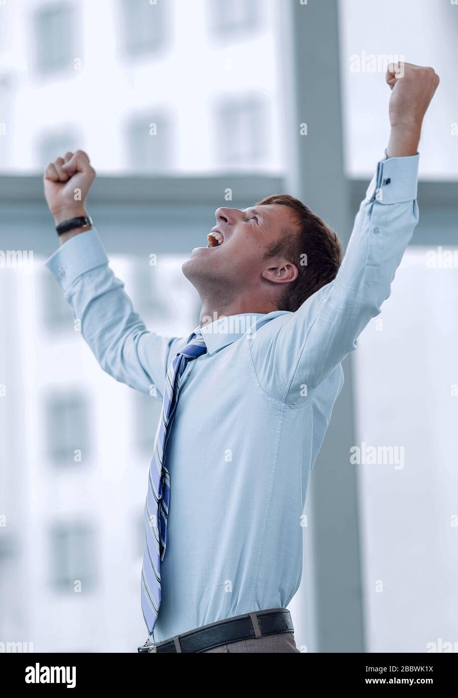 Businessman celebrating with his fists raised in the air Stock Photo ...