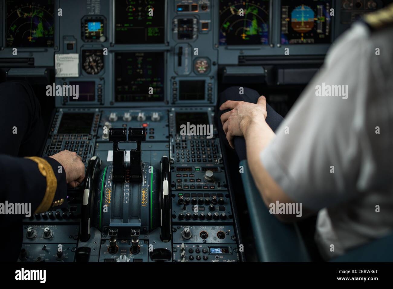 Pilot's hand accelerating on the throttle in a commercial airliner ...