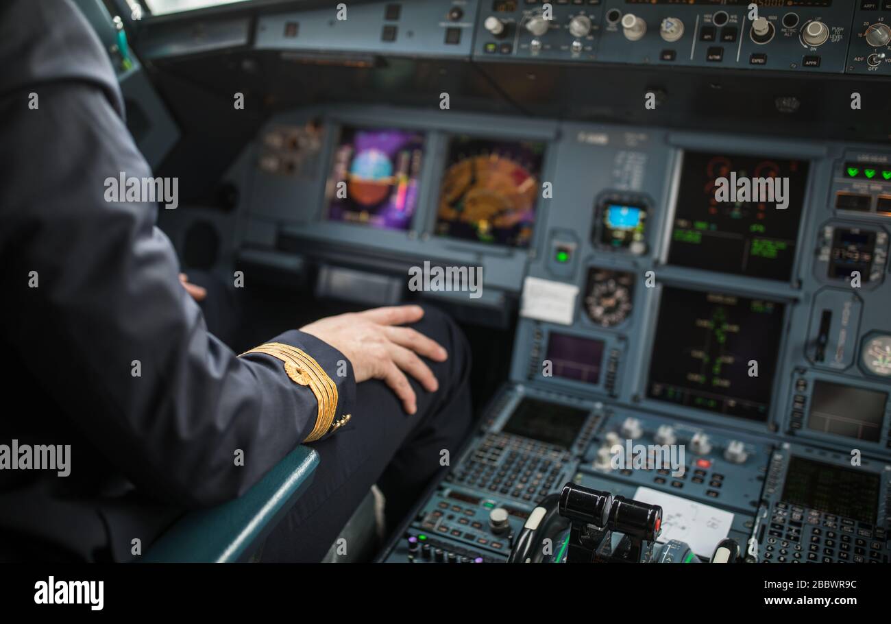 Pilot's hand accelerating on the throttle in a commercial airliner ...