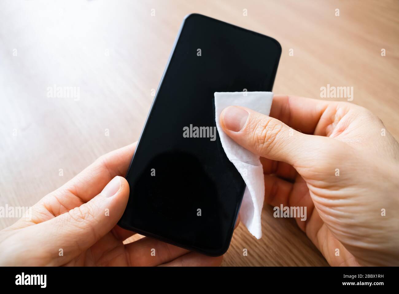 Man Wiping Mobile Phone Screen With Sanitizer Stock Photo Alamy