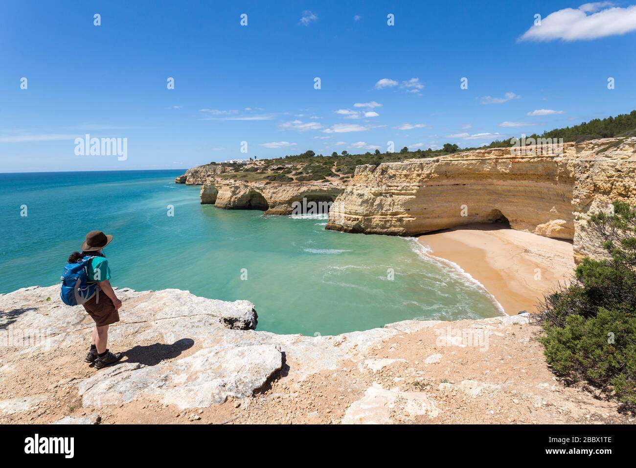 Walker on the coast walk to the west of Alporchinhas, Algarve, Portugal Stock Photo