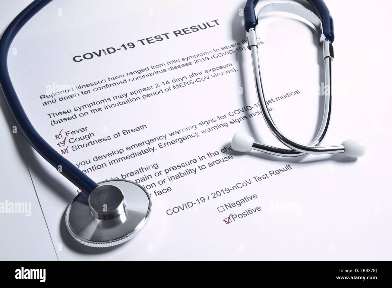 Positive test result for COVID-19 or novel coronavirus pandemic. Stethoscope and novel coronavirus test result on doctor's table Stock Photo