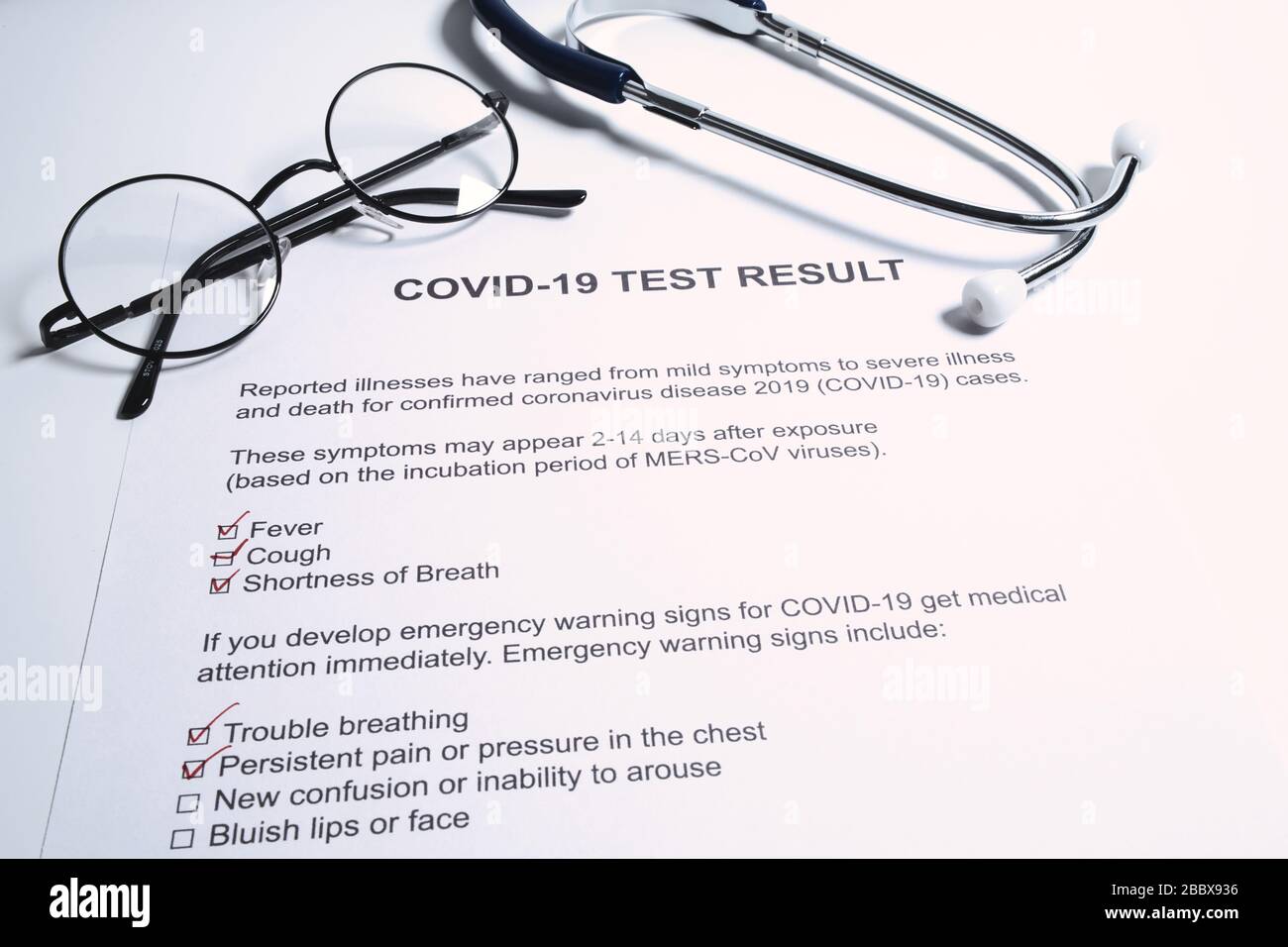 Positive test result for COVID-19 or novel coronavirus pandemic. Stethoscope and novel coronavirus test result on doctor's table Stock Photo