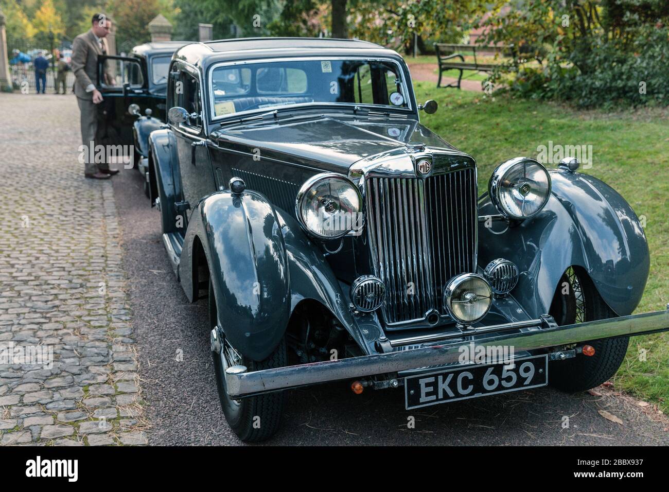 2 vintage motor cars headed by a 1938 MG SA Saloon EKC 659, Papplewick Pumping Station 1940's event, England Stock Photo