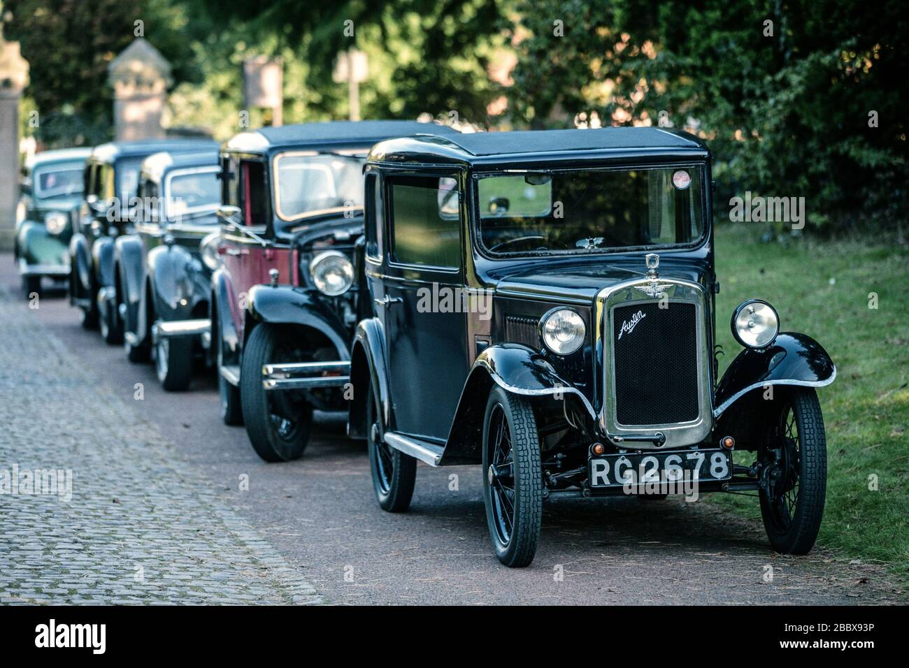 A line of vintage motor cars headed by a 1932 Austin Seven RN BOX SALOON RG 2678, Papplewick Pumping Station 1940's event, England Stock Photo