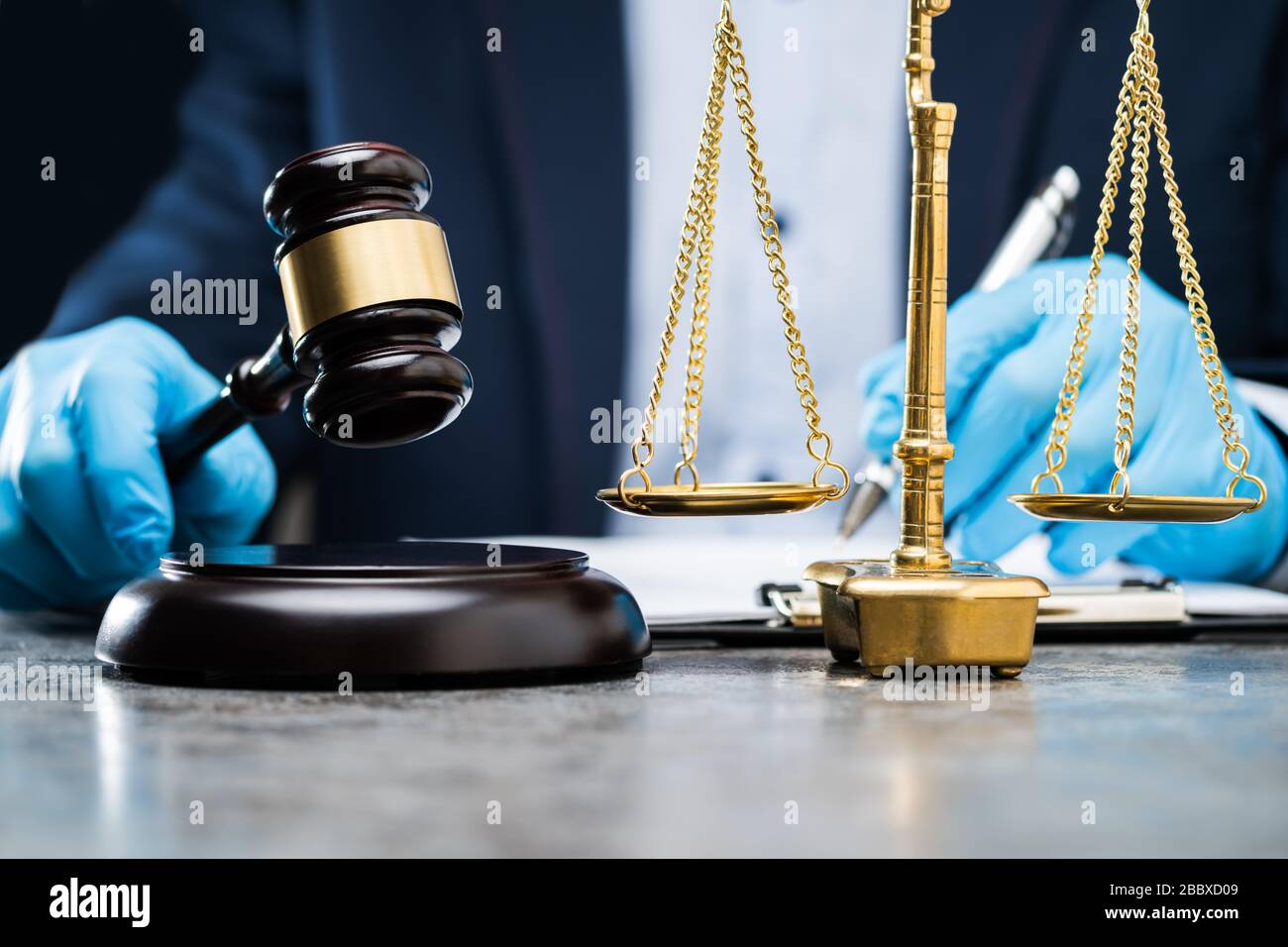 Judge In Gloves To Protect From Coronavirus Writing On Paper Stock Photo