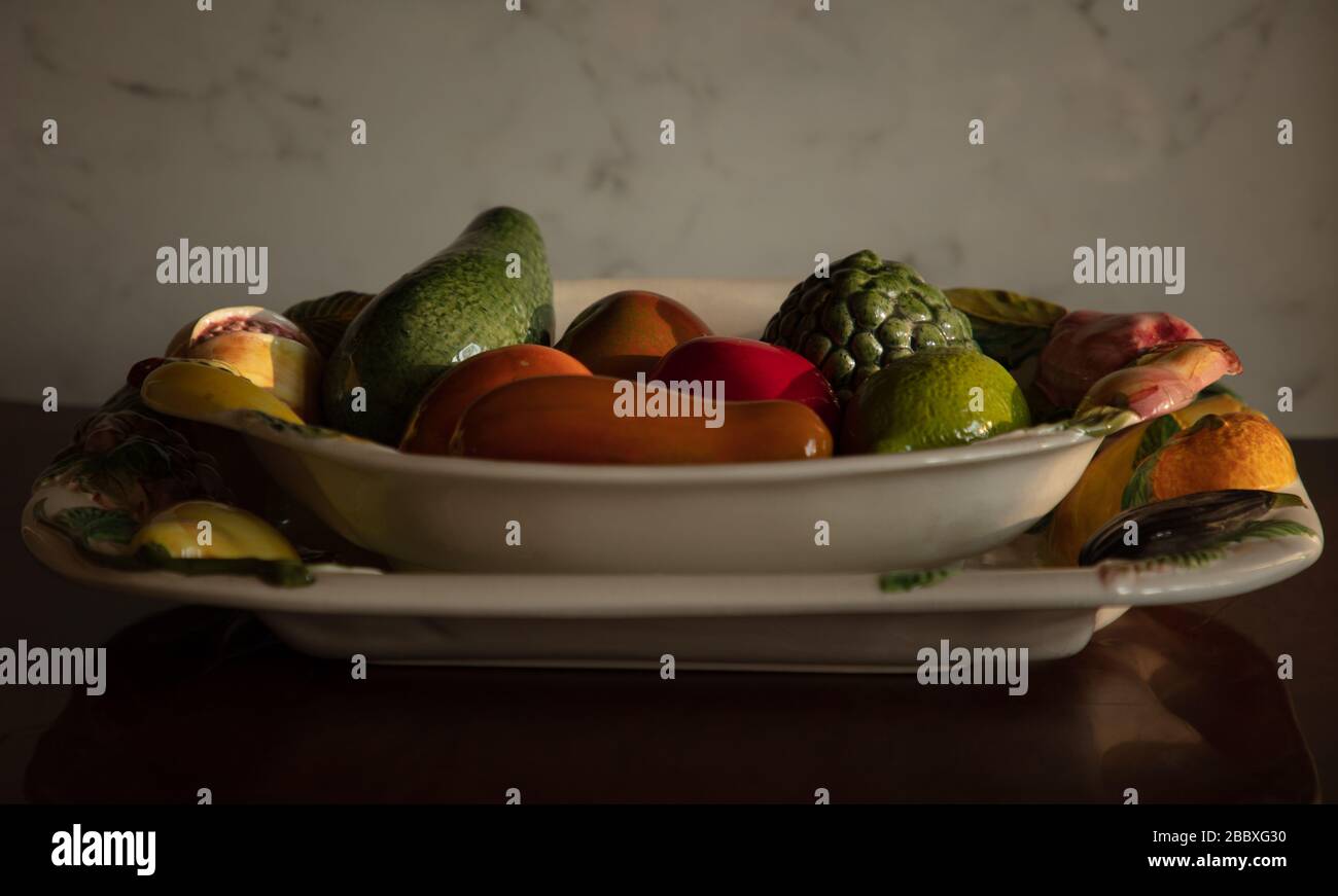 Ceramic fruit bowl and fruits seen on a table top in a London home