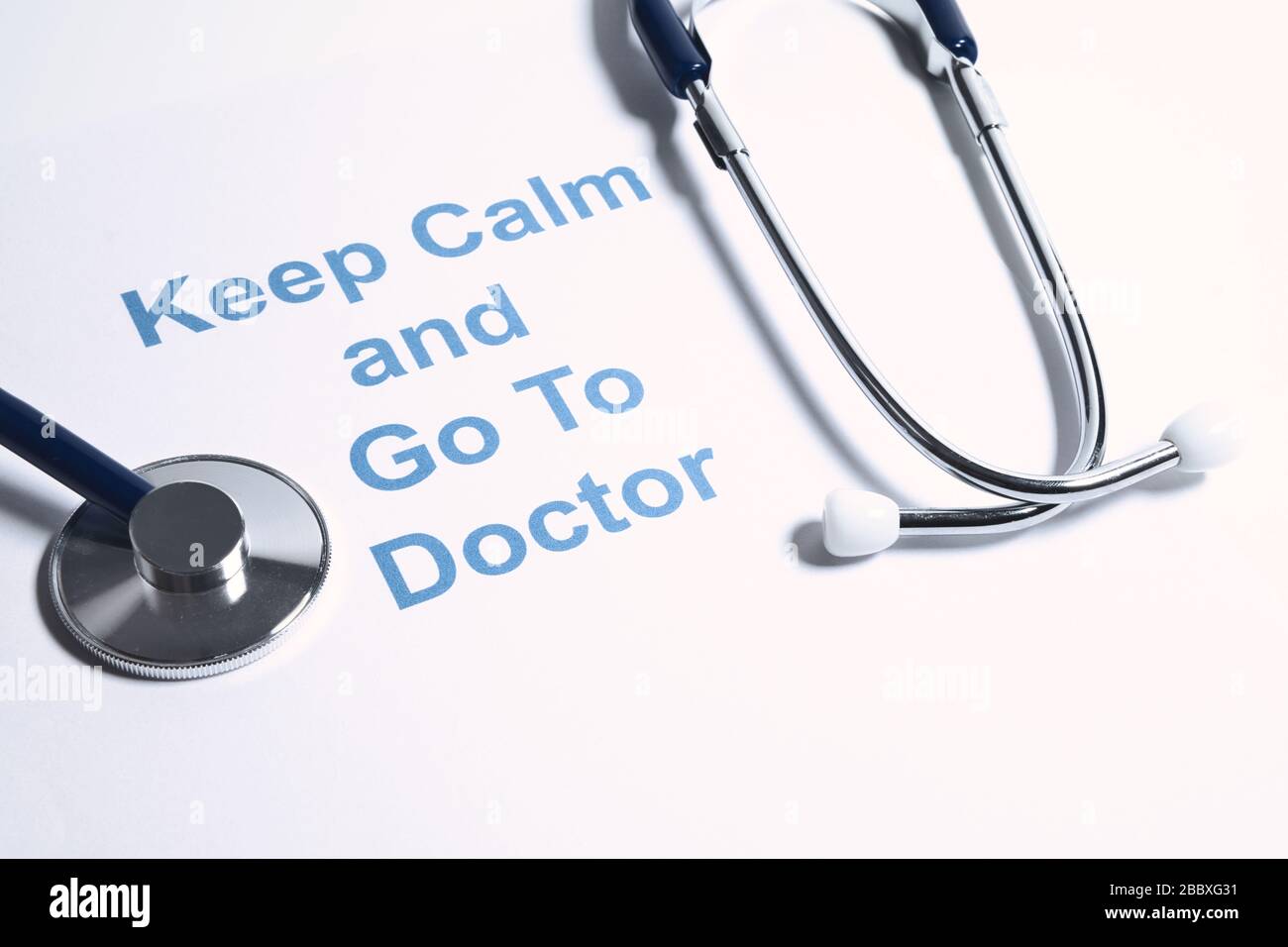 Concept idea for doctor advice, health or disease diagnosis. Keep calm and go to doctor text with stethoscope. Stock Photo