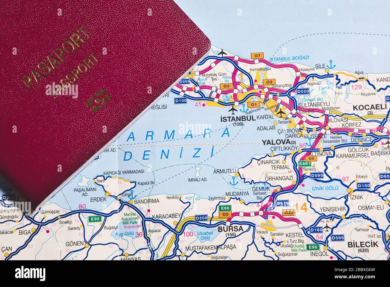 Travel to Istanbul or travel to Turkey concept idea photo, claret red passport on Istanbul, Turkey map Stock Photo