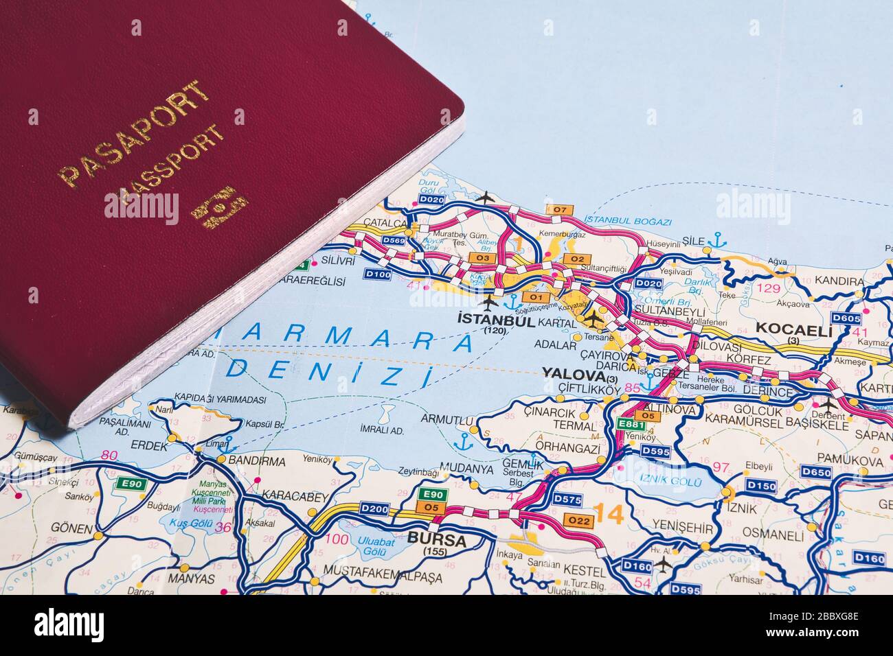 Travel to Istanbul or travel to Turkey concept idea photo, claret red passport on Istanbul, Turkey map Stock Photo