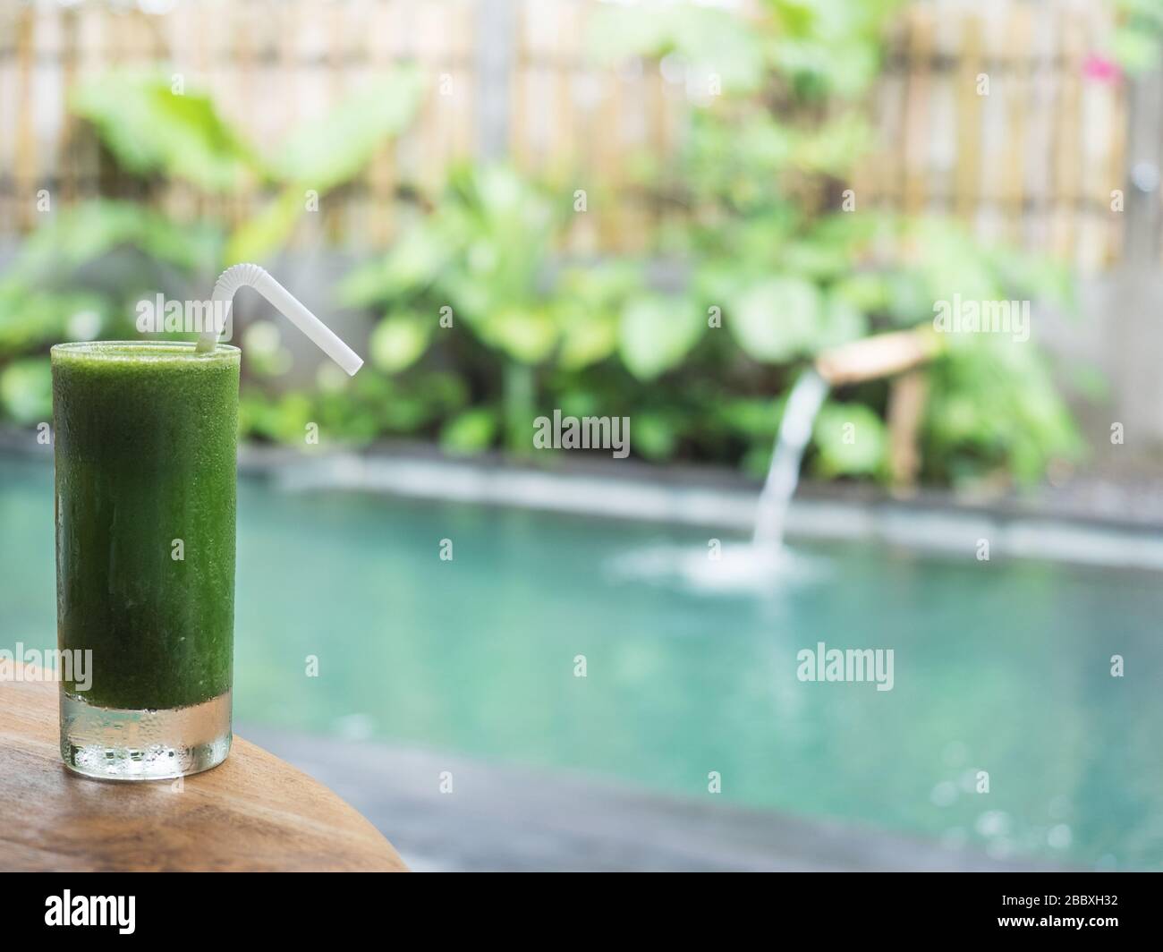 Green vegetables detox juice. swimming pool backgroud Stock Photo