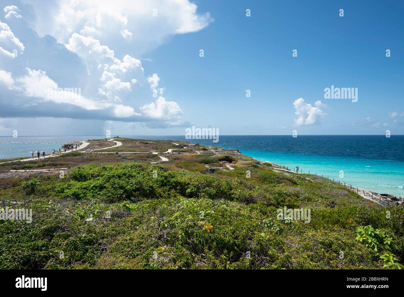 Panoramic view of the southern tip in Isla Mujeres Mexico. In the background a group of tourists strolling and the Caribbean sea. Travel and vacation Stock Photo