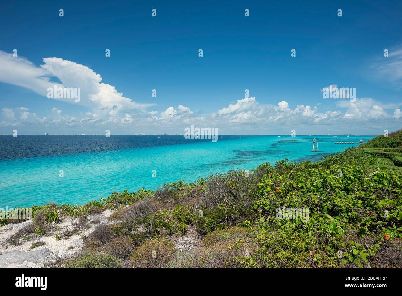 Panoramic view of the southern tip in Isla Mujeres Mexico. In the background a group of tourists strolling and the Caribbean sea. Travel and vacation Stock Photo