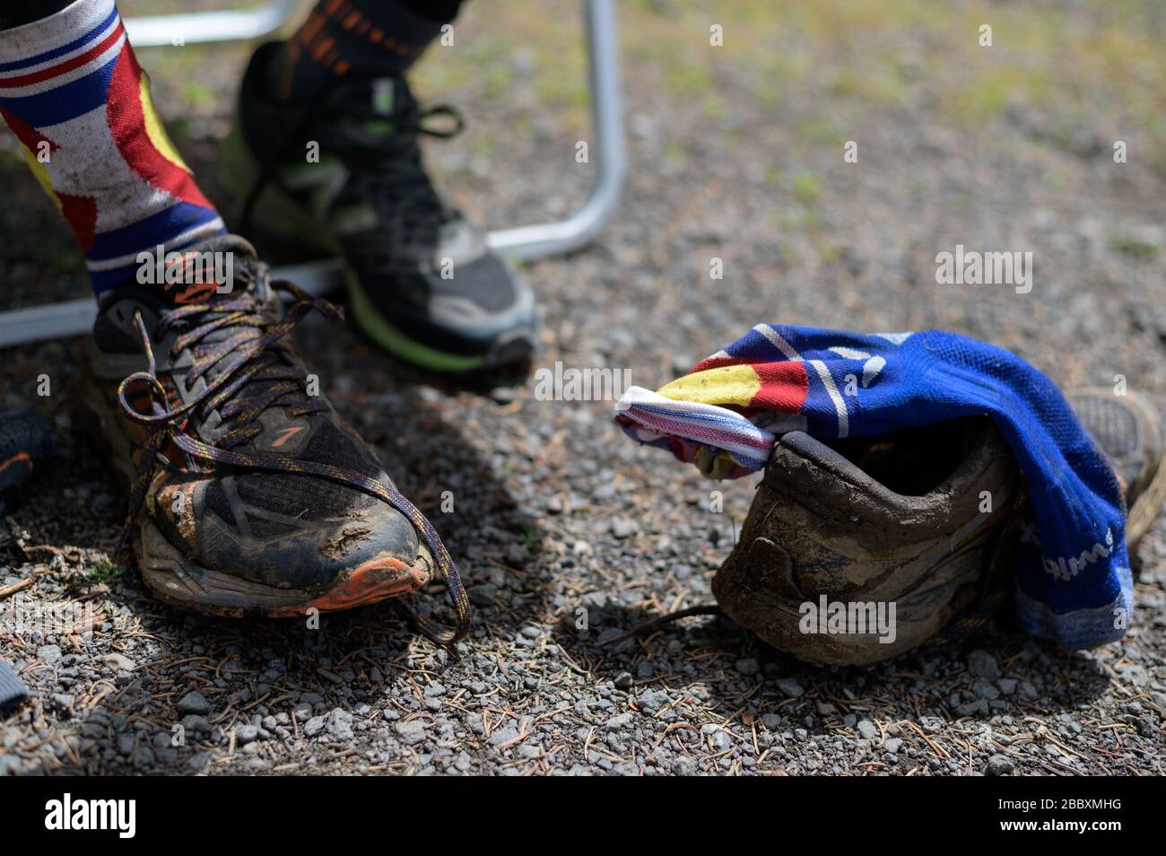 A race participant changes his shoes after 35 miles on the trail. Stock Photo