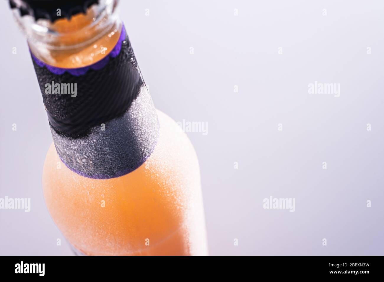 Refreshing frozen drink bottle isolated on gray background Stock Photo