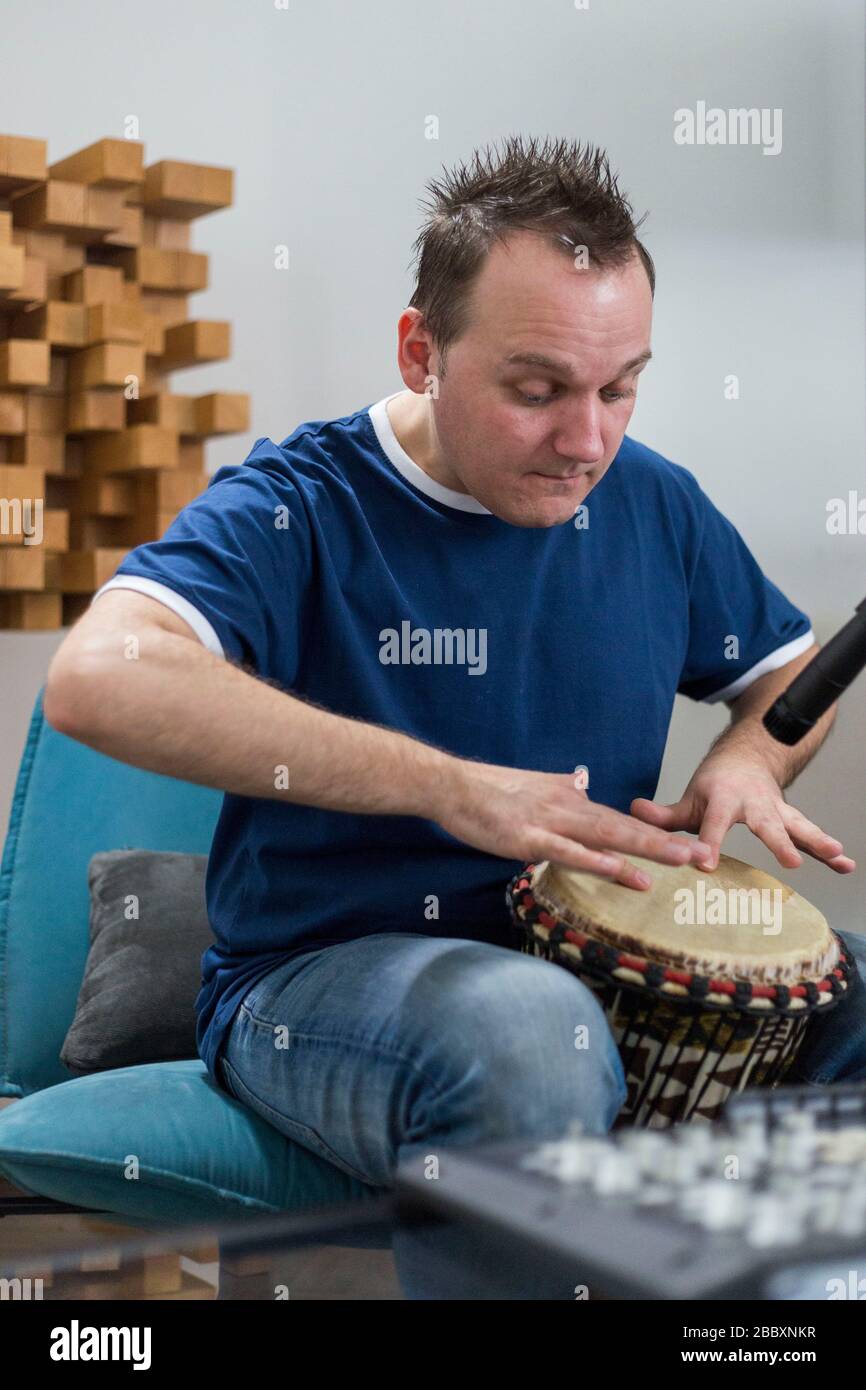 Professional musician recording djembe drum instrument in digital