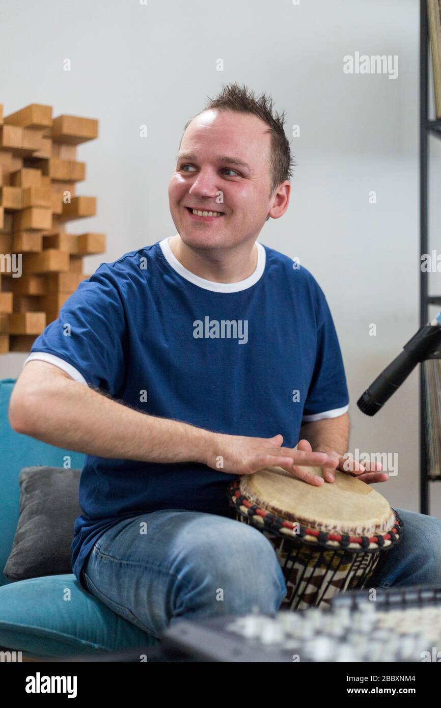 Professional musician recording djembe drum instrument in digital