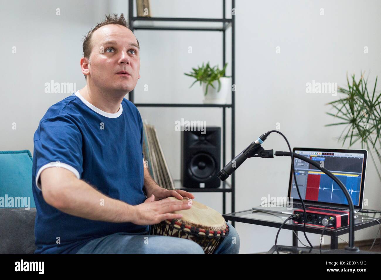 Professional musician recording djembe drum instrument in digital