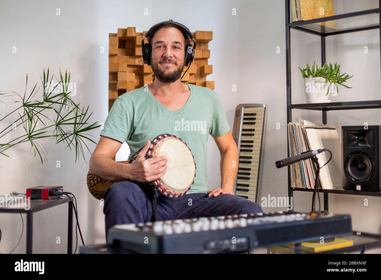 Professional musician recording djembe drum instrument in digital