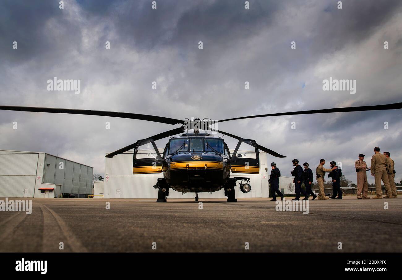 Members of the U.S. Customs and Border Protection, Office of Field Operations Special Response Team, along with Air and Marine Operations flight crew, board a UH-60 Black Hawk helicopter prior to an air-intercept training exercise as they provide airspace security for Super Bowl LI, in Conroe, Texas, Feb. 1, 2017. Units with Air and Marine Operations and Office of Field Operations teamed up with the Civil Air Patrol  to practice an air-to-air intercept using two AMO UH-60 Black Hawk helicopters and two C-550 Citation jets to track down a simulated incursion into restricted airspace. Stock Photo