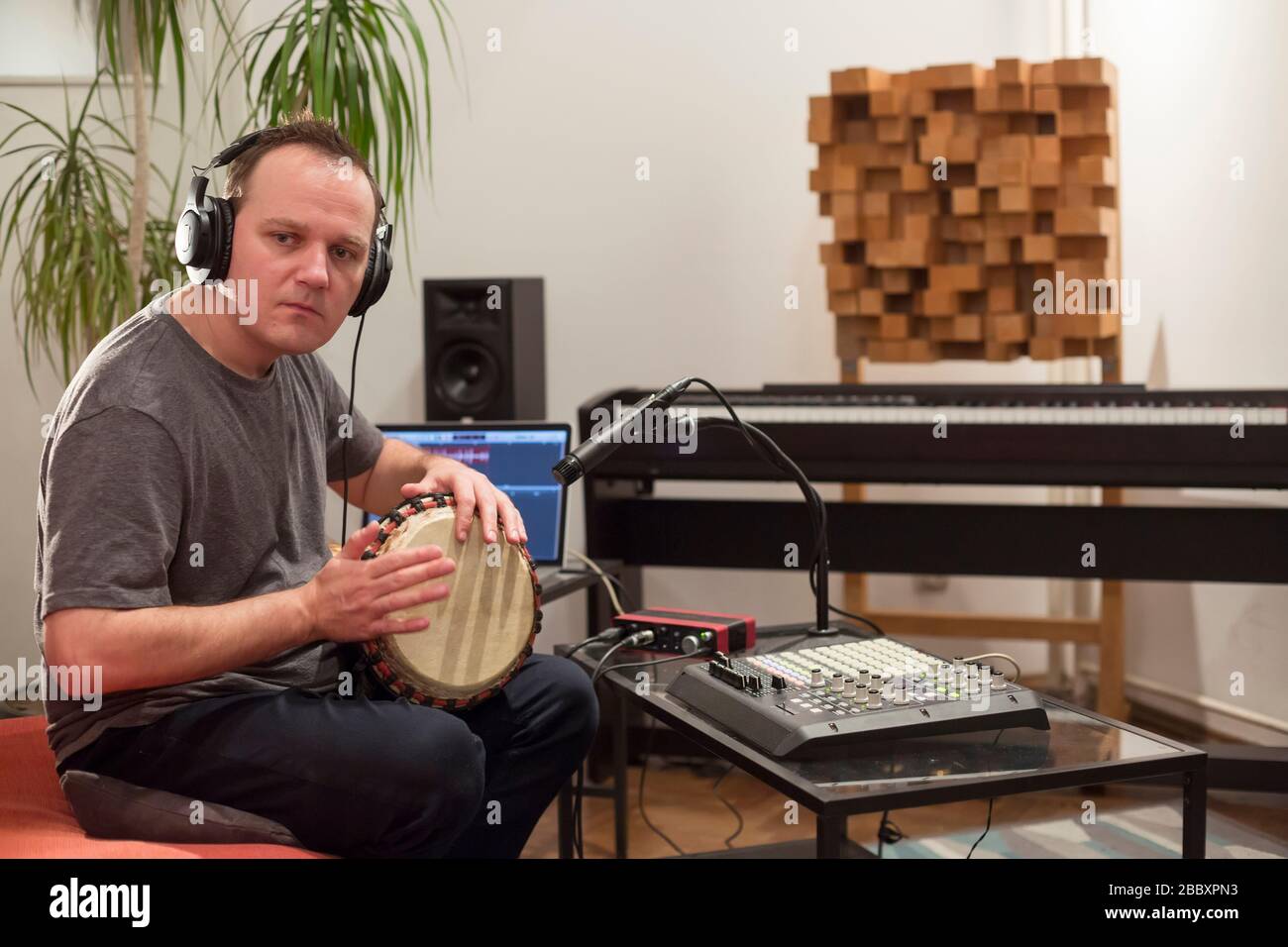 Professional musician recording djembe drum instrument in digital