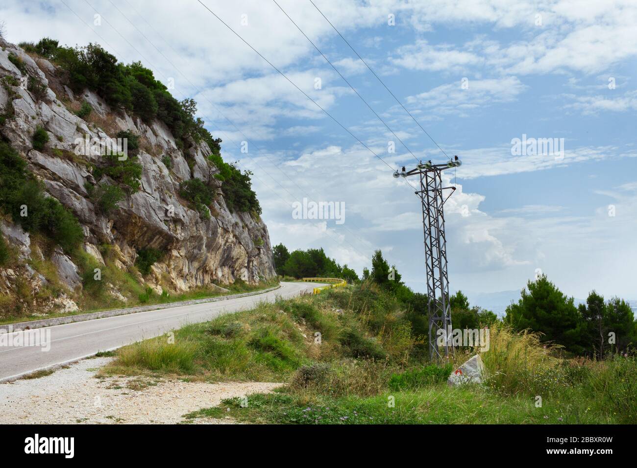 power line in the mountains near the road in Croatia Stock Photo