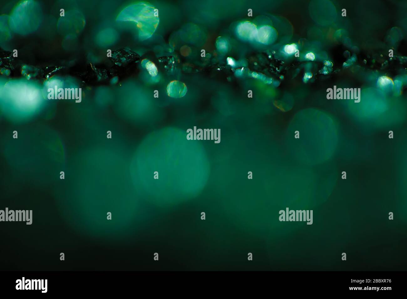 Monochrome emerald abstract background with bokeh defocused lights. Stock Photo