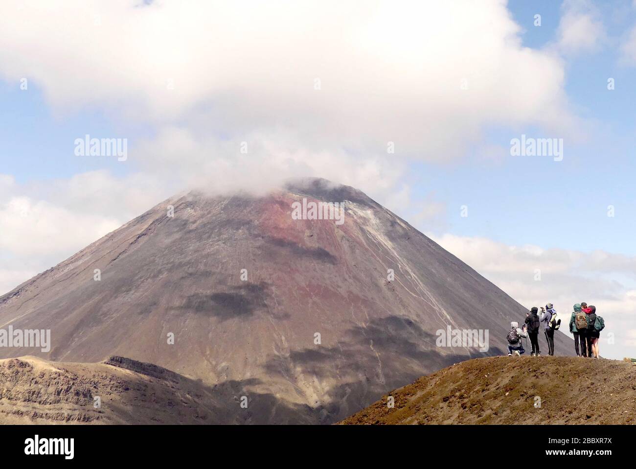 A group of hikers look towards Mount Ngauruhoe (Mount Doom) in Tongariro National Park, New Zealand Stock Photo