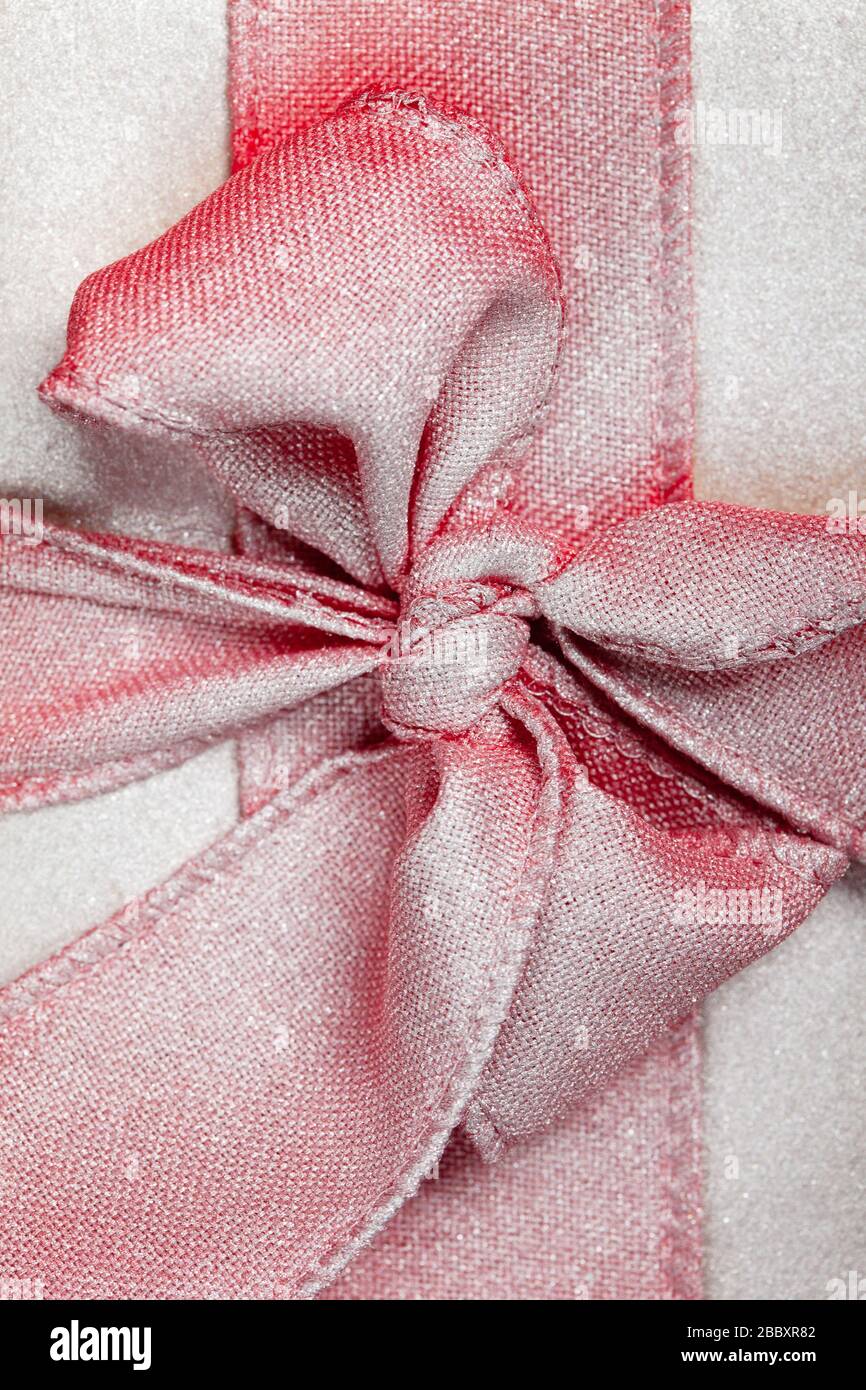 large red bow in silver on a gift box. Stock Photo