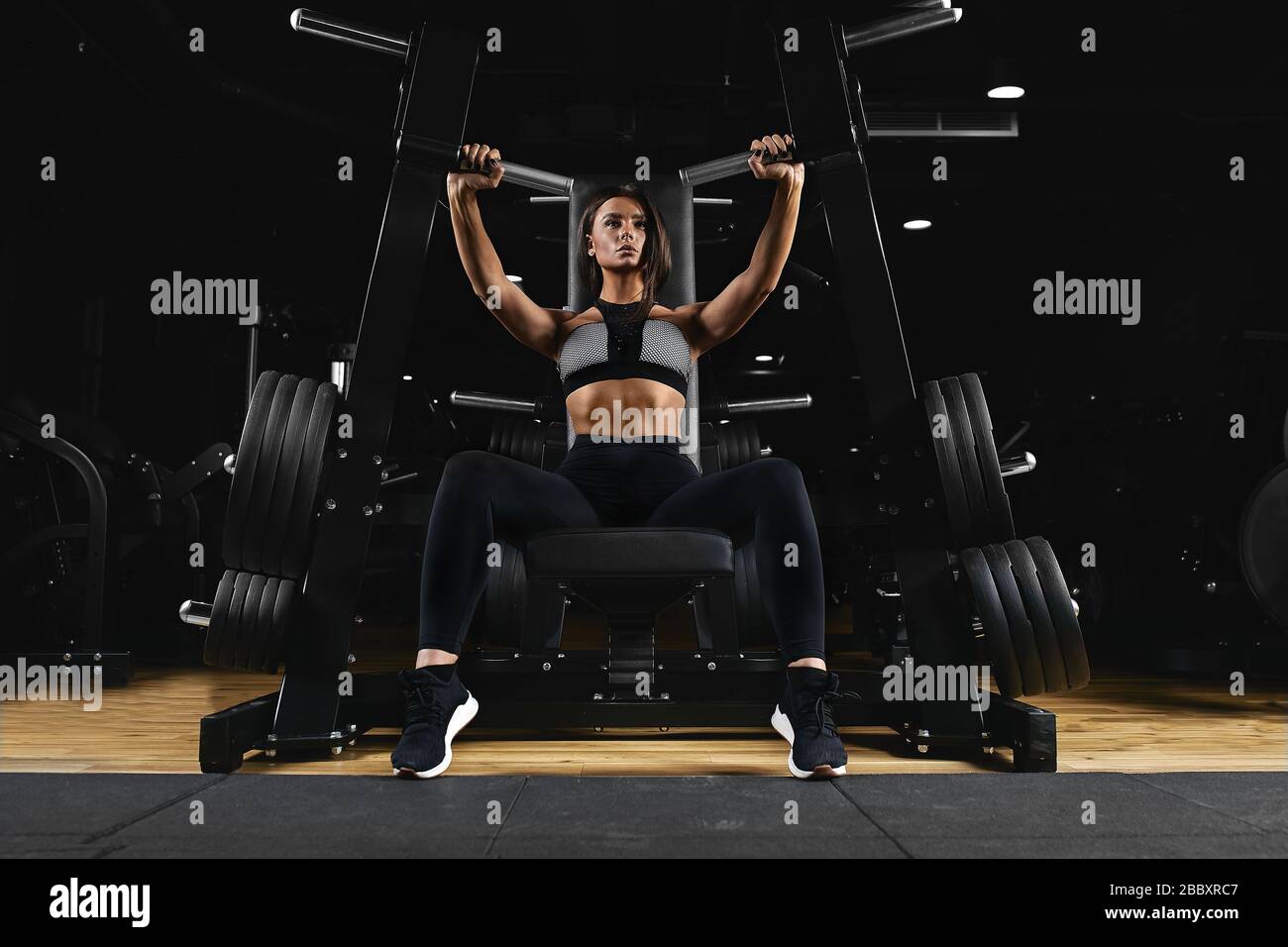 Slim, bodybuilder girl, does the exercises for arms in the gym. Sports  concept, fat burning and a healthy lifestyle Stock Photo - Alamy