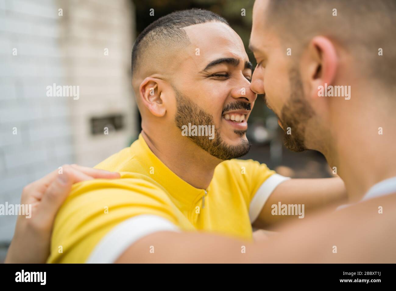 Portrait of happy gay couple spending time together and hugging in the