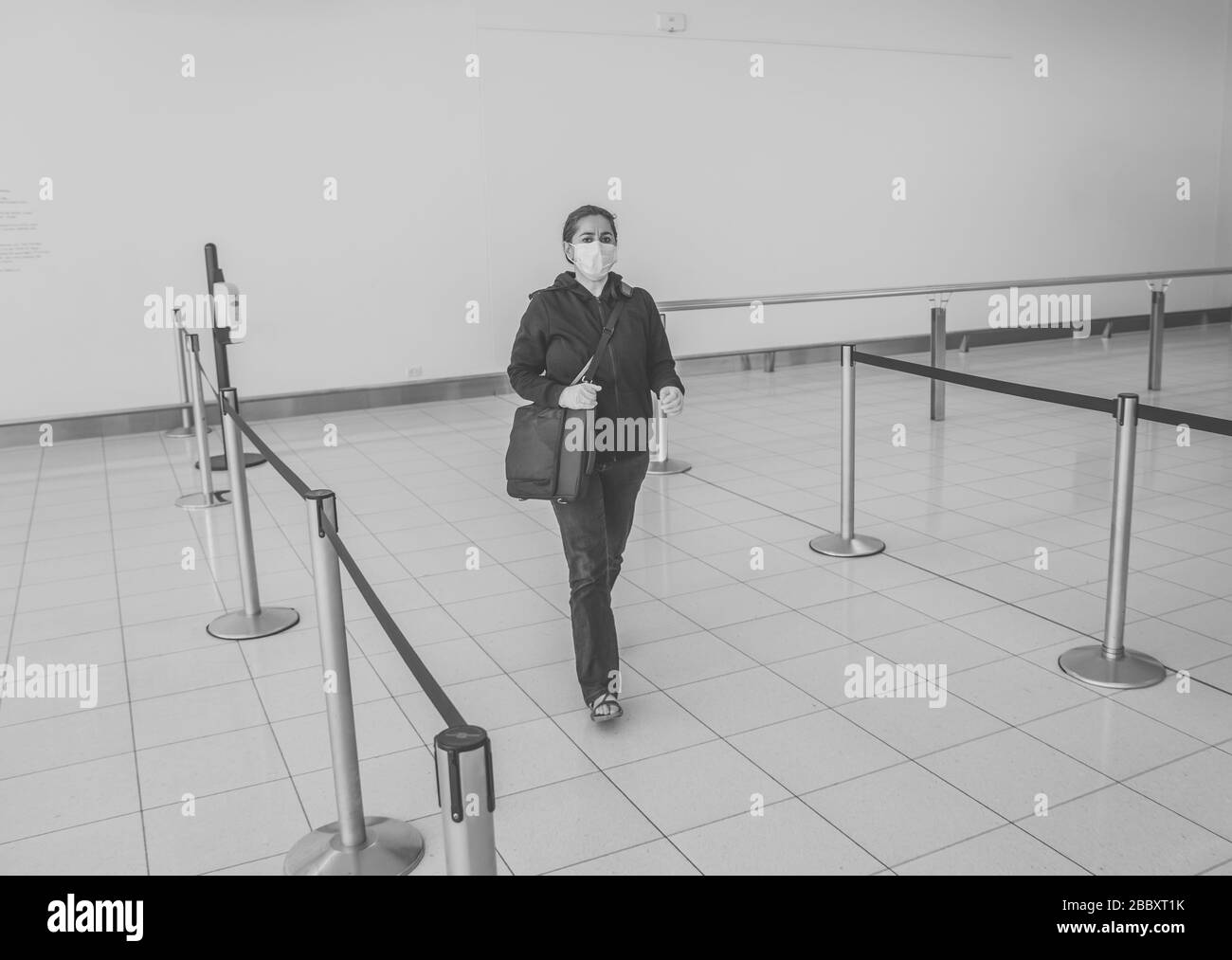 COVID-19 Pandemic restrictions. Young woman waiting at the airport to return home city after being stuck in a foreign country as governments have rest Stock Photo