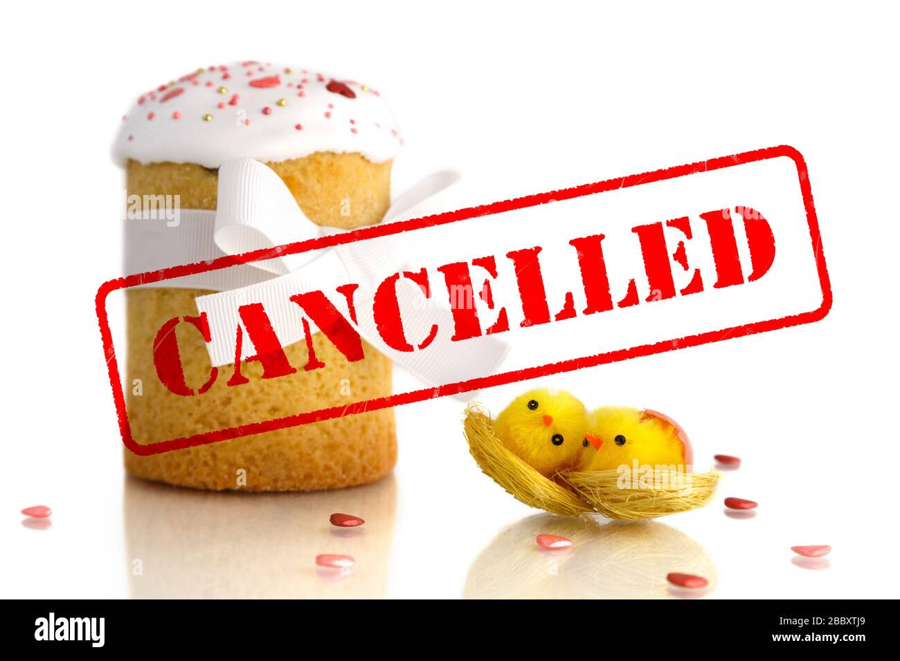 Cancellation of Easter celebration because of coronavirus. Quarantined Easter, stay home concept. Traditional Easter cake with two yellow chicks Stock Photo