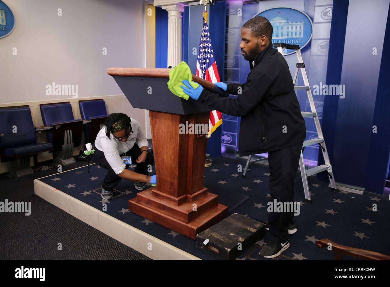 Washington DC, USA. 01st Apr, 2020. Workers clean the podium in the White House briefing room ahead the coronavirus task force briefing with President Donald Trump, on April 1, 2020, in Washington. Credit: MediaPunch Inc/Alamy Live News Stock Photo