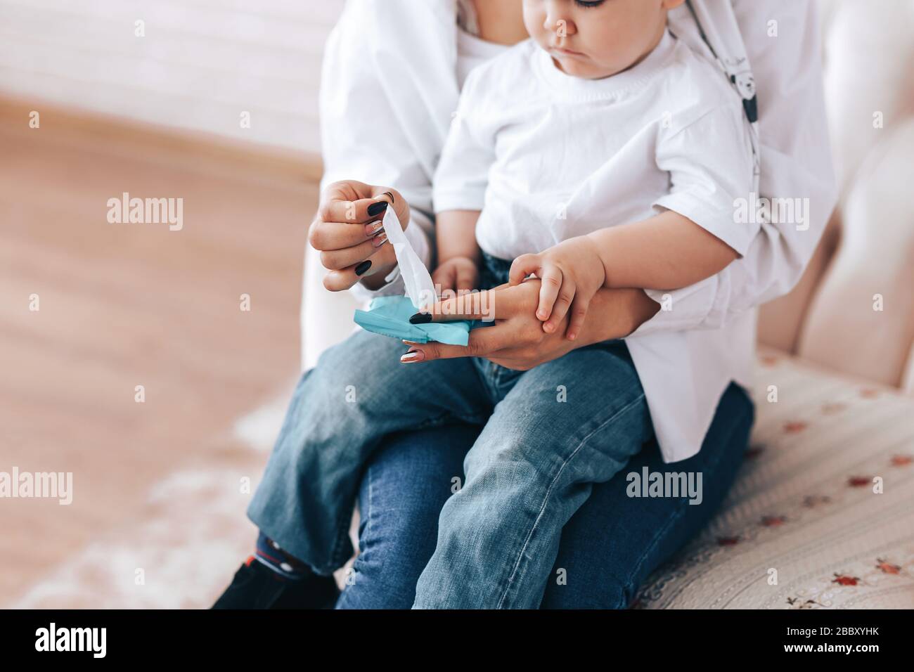 Mother and child wipe their hands with disinfectant wipes, how to wipe