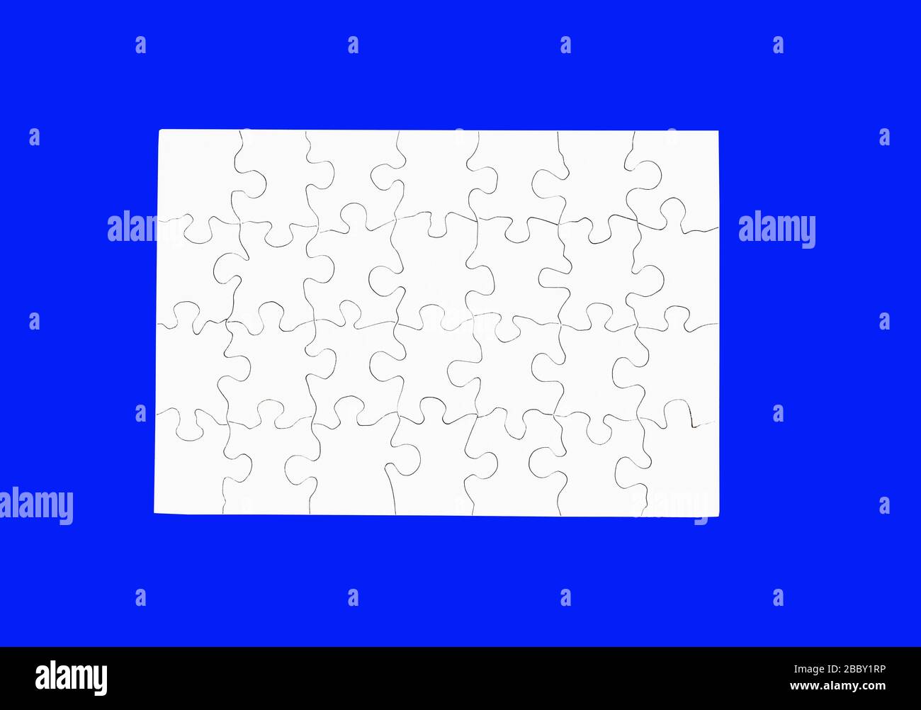 Blank White Puzzle isolated on blue Stock Photo