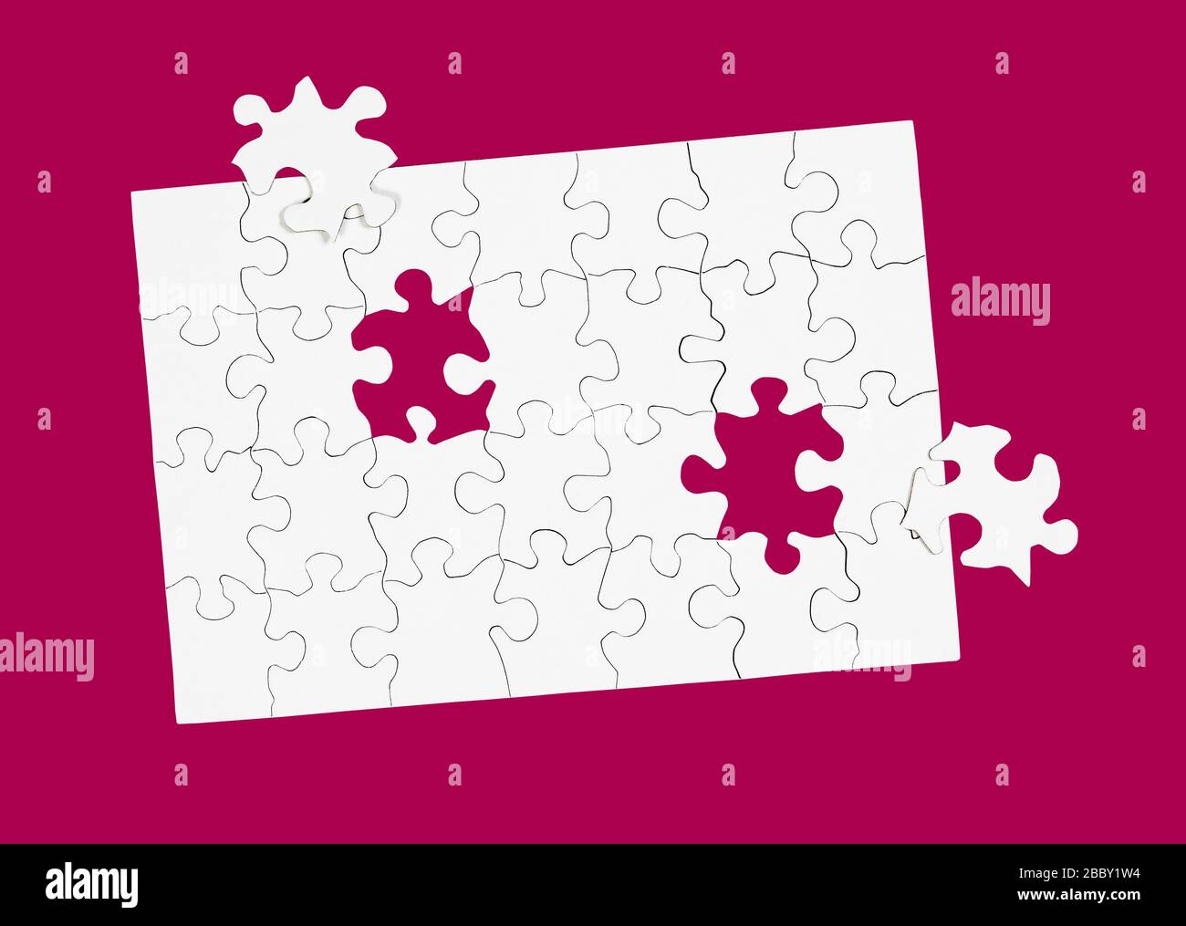 Blank White Puzzle with Two Pieces Missing isolated on dark pink Stock Photo