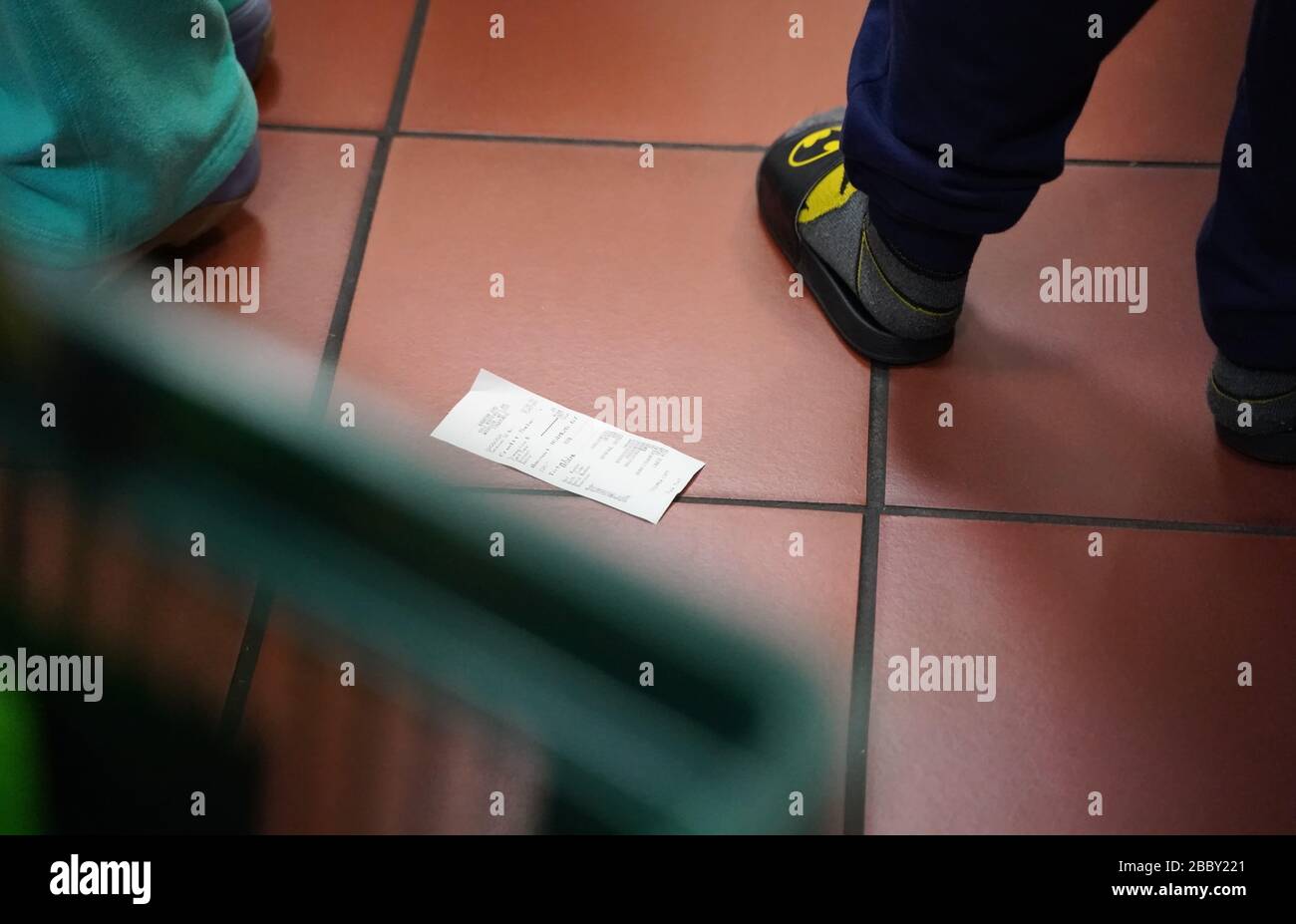 New York, NY / USA - February 28, 2020: A discarded receipt lies on the grocery store floor Stock Photo
