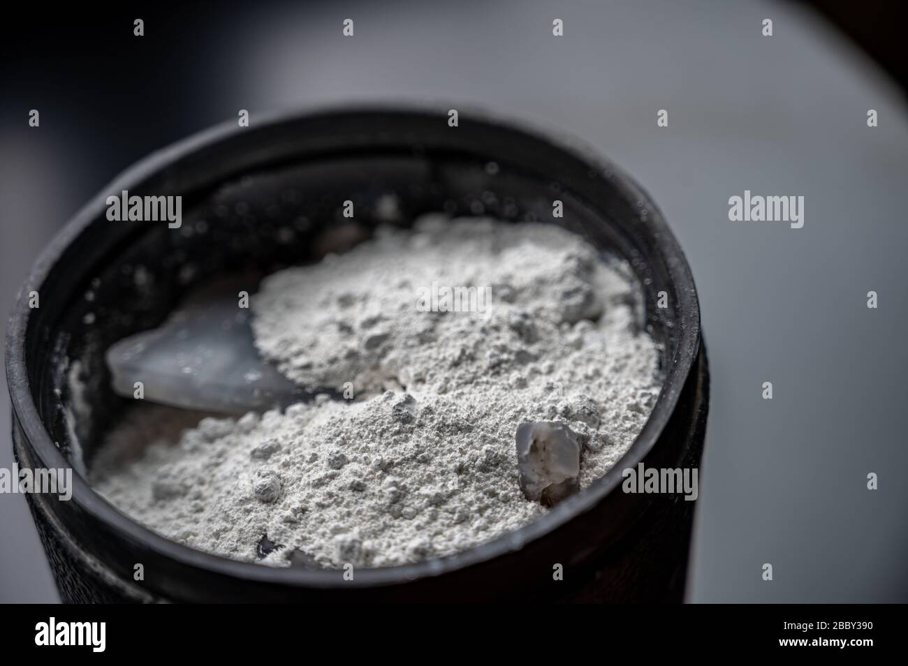 Final stage of rock tumbling media and polish in rubber barrel Stock