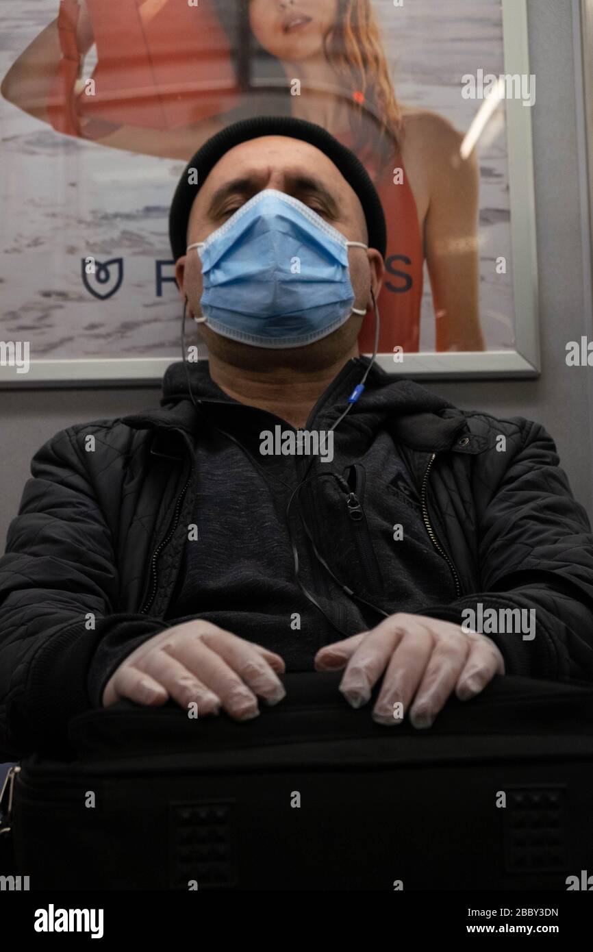 New York, United States. 31st Mar, 2020. A man wearing a face mask and gloves rides the subway in NYC amid the coronavirus outbreak.The state of New York has turned into the epicenter of the COVID-19 coronavirus in the United States with over 75,000 confirmed cases and 1,500  deaths reported. Credit: SOPA Images Limited/Alamy Live News Stock Photo