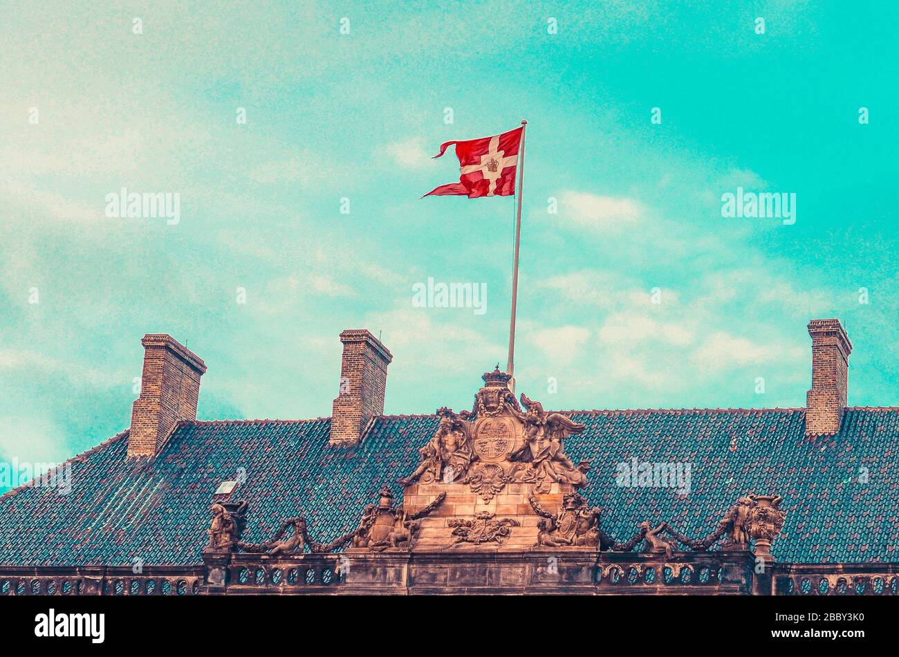 National Danish flag on the Royal Palace Amalienborg. Copenhagen, Denmark Stock Photo