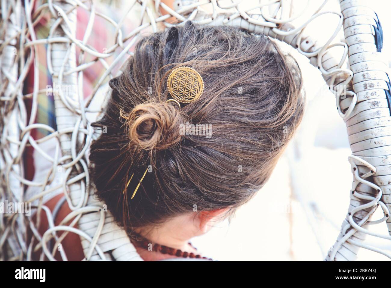 Elegant woman in a swing wearing metal hair pin in her hair bun Stock Photo